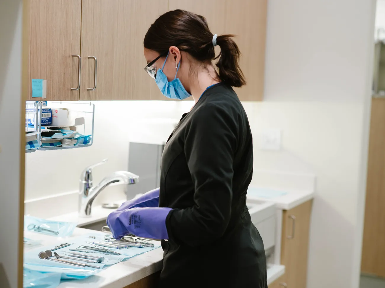 Dental assistant sterilizing instruments at CrossPointe Dental