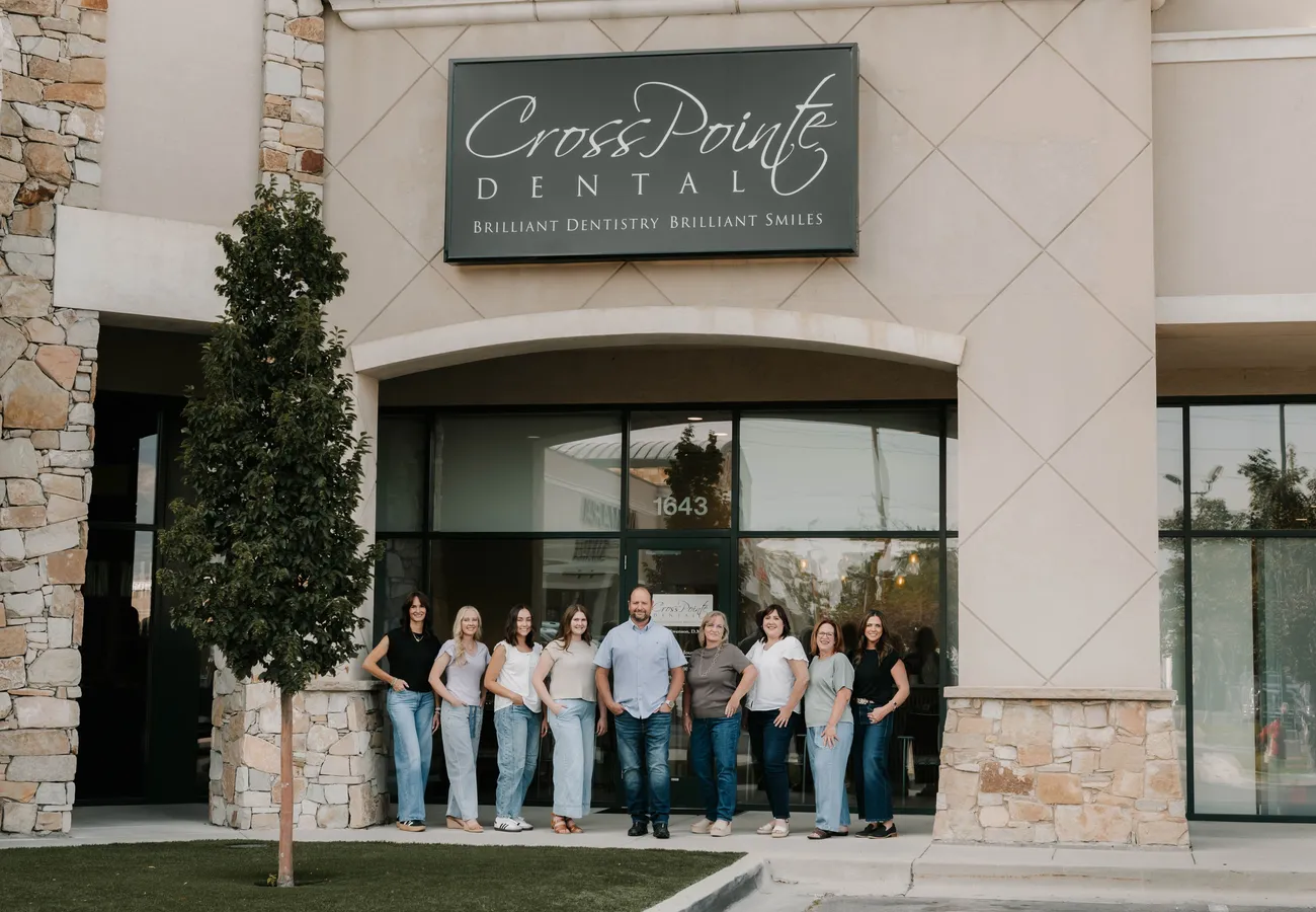 The CrossPointe Dental team standing outside the office storefront in Orem, UT